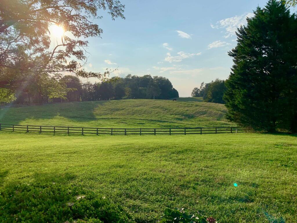 The sun setting over the pasture at the Farmhouse at Beautiful Run