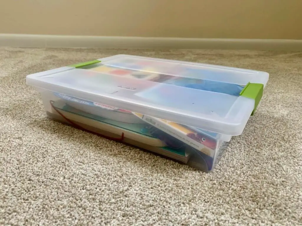 Plastic storage bin for toddler road trip essentials
