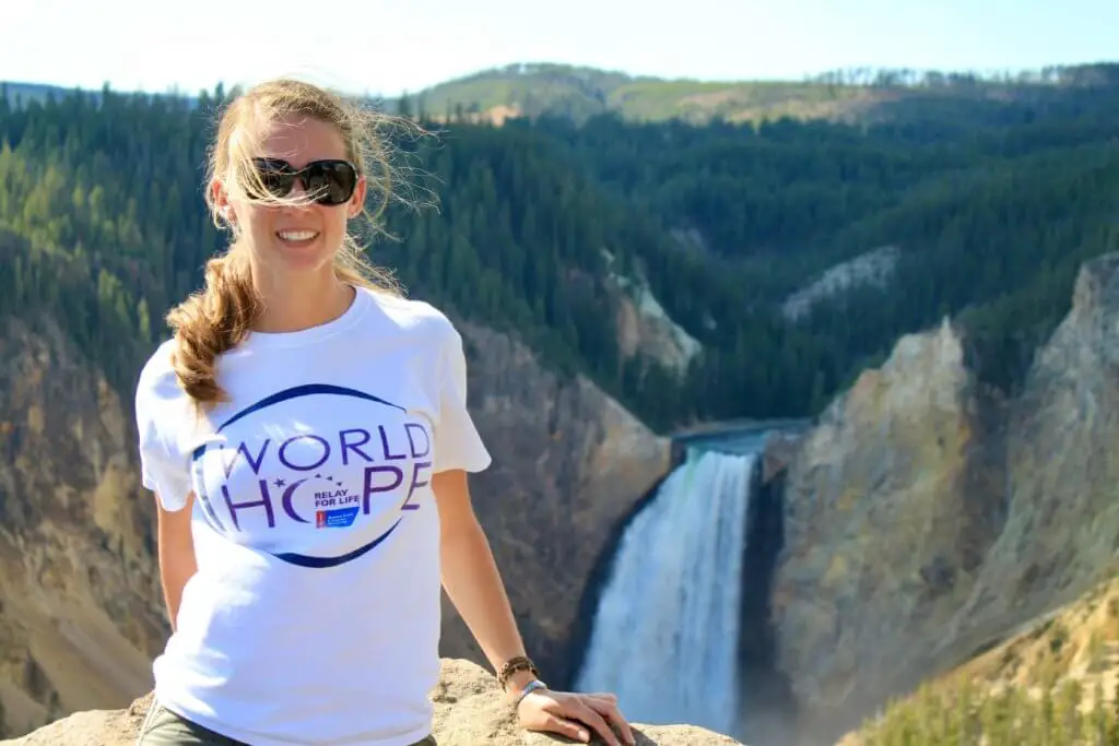 Gwen smiling in front of Yellowstone Falls