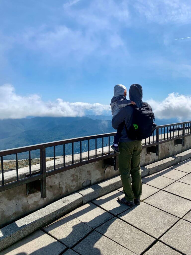 M holding E at the top of Mount Washington