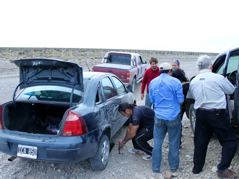 Accident scene with people working on the car