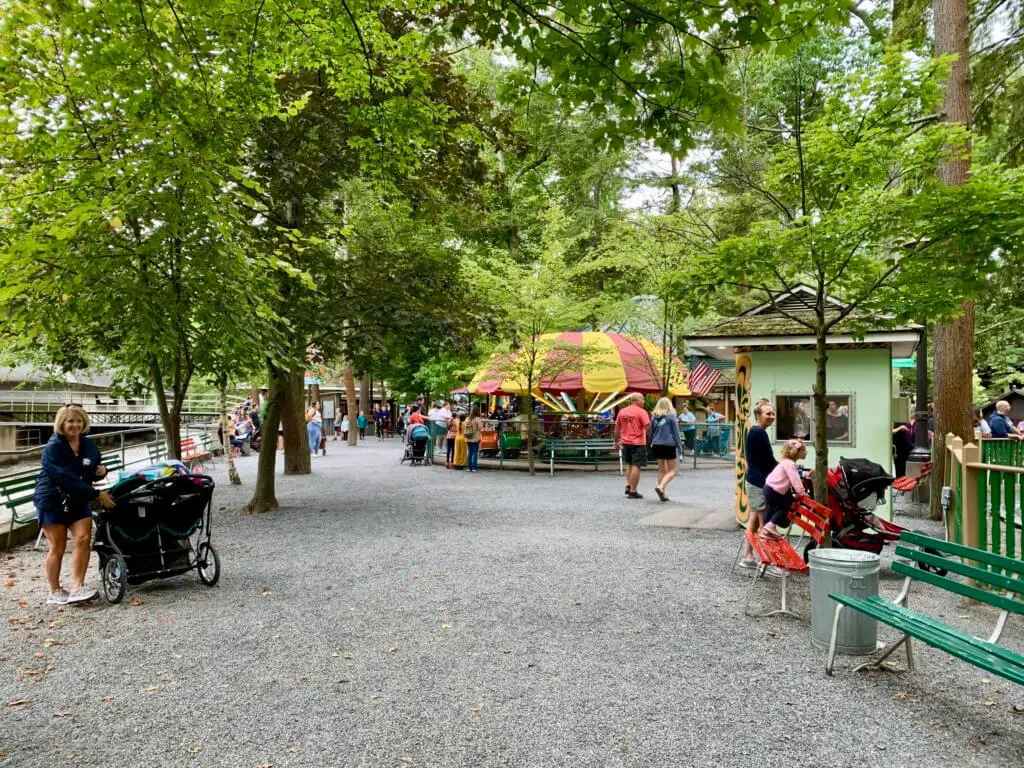 Gravel pathways, trees, and distant rides at Knoebels