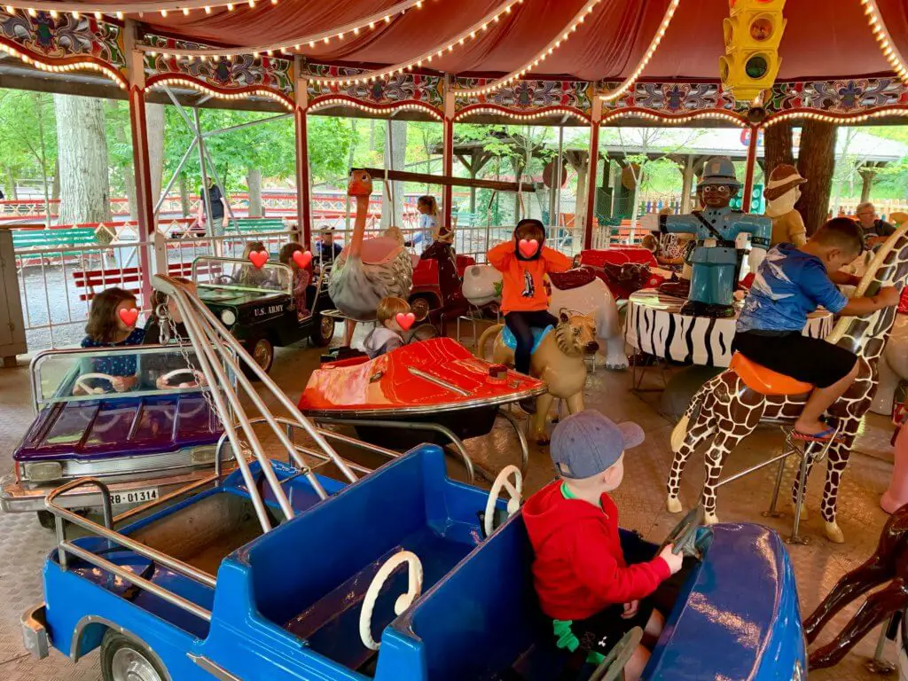 Kiddie carousel with various cars, animals, and other seats for kids