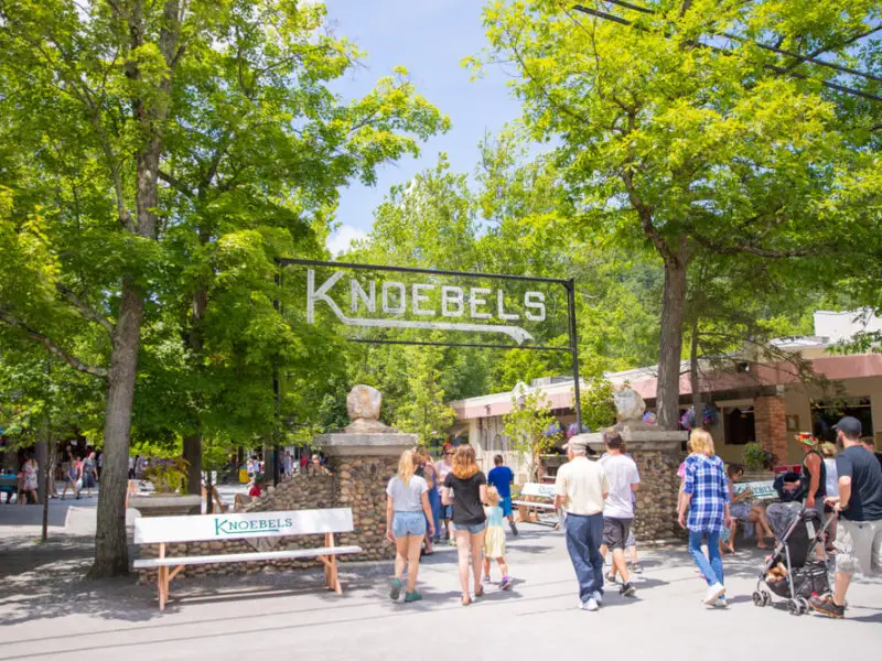 Entrance to Knoebels Amusement Resort, with trees and park bench.
