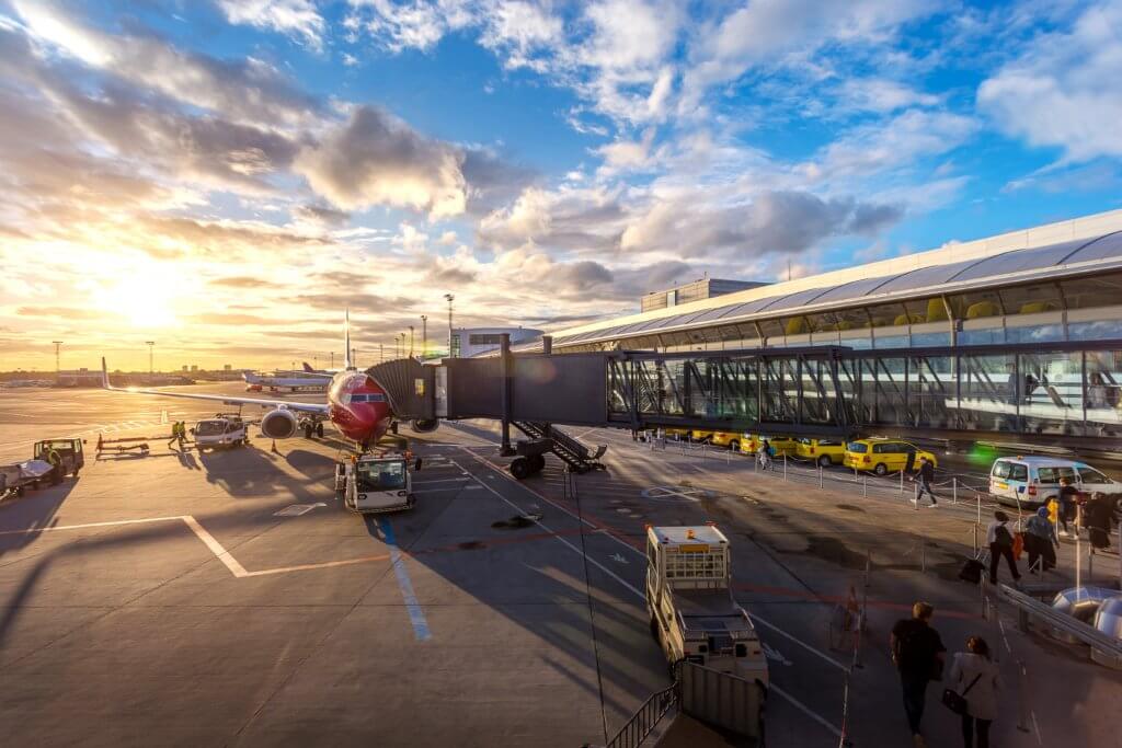 Airplane at gate at sunset