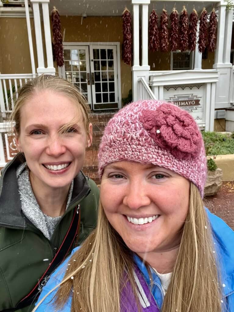 Gwen and Molly smiling with snow flurries falling.