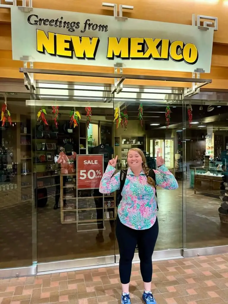 Molly under a "Greetings from New Mexico" sign