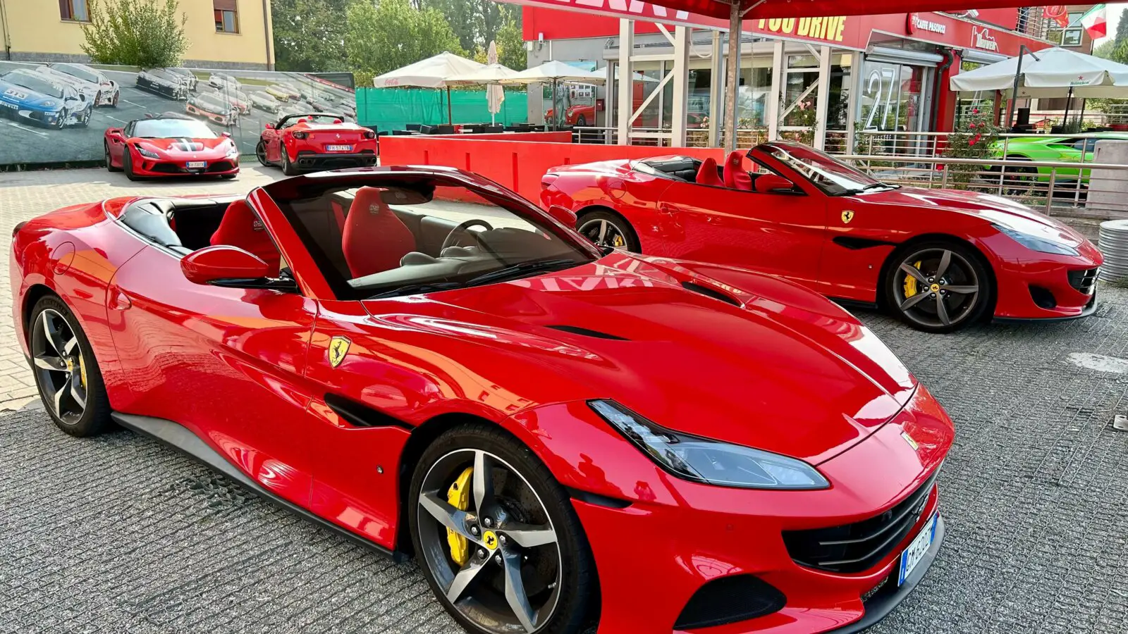 Two red Ferraris parked in Maranello, Italy