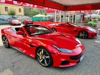 Two red Ferraris parked in Maranello, Italy
