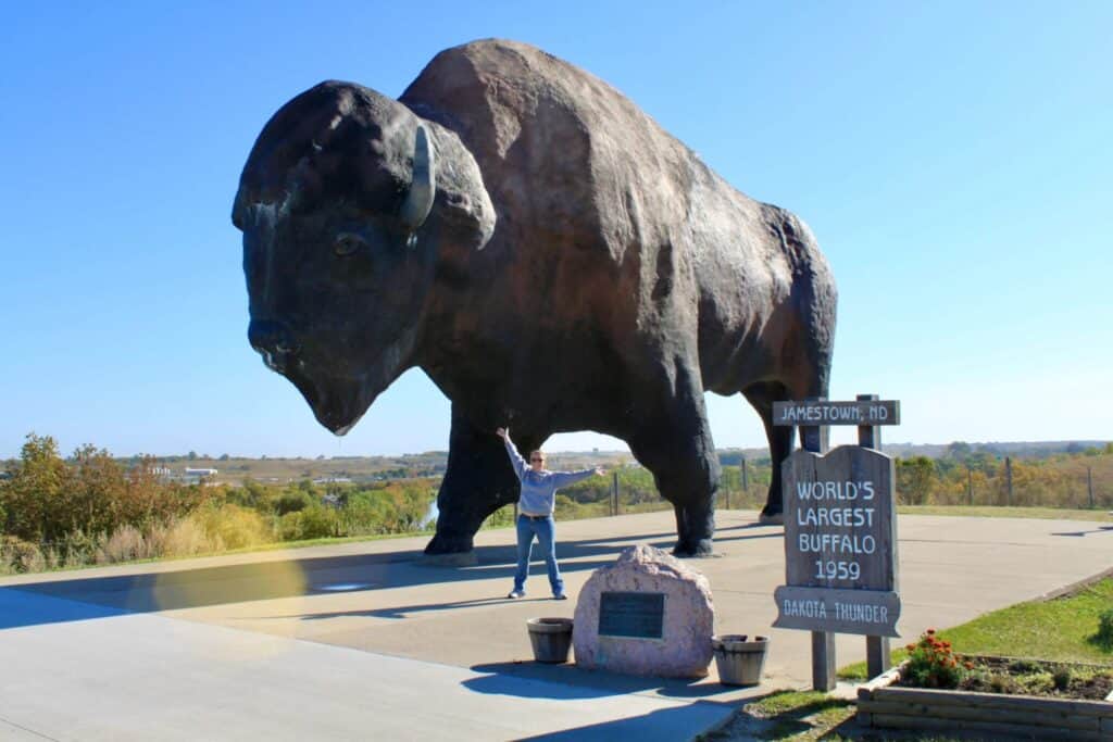 Molly standing in front of an enormous buffalo statue